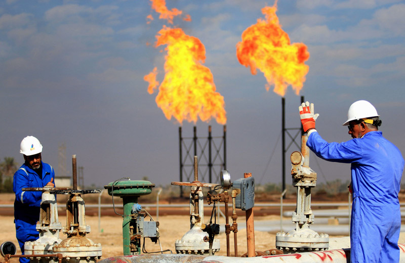 Công nhân làm việc tại một cơ sở khai thác dầu ở Basra, Iraq. Ảnh: AFP/TTXVN