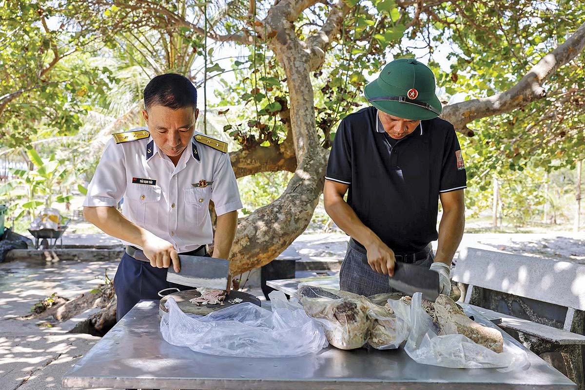 Trung tá Trần Mạnh Tuấn (bên trái) cùng thành viên Tổ phở ở đảo Sinh Tồn (Ảnh: Bình Phạm)