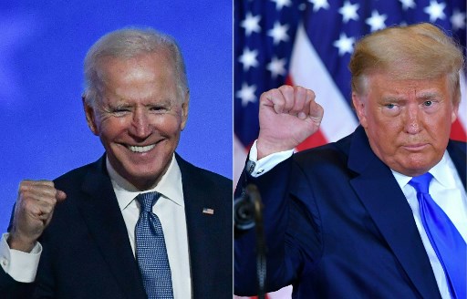 Joe Biden hay Donald Trump trúng cử tổng thống Mỹ sẽ phải đối diện với vấn đề rất lớn của nước Mỹ: kiểm soát được đại dịch Covid-19, nhưng vẫn phát triển kinh tế. Ảnh: AFP