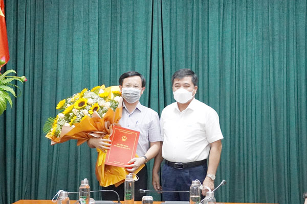 Phó Chủ tịch UBND tỉnh Quảng Bình Đoàn Ngọc Lâm trao quyết định và tặng hoa cho ông Hoàng Hữu Thái, Giám đốc Sở Thông tin và Truyền thông Quảng Bình.
