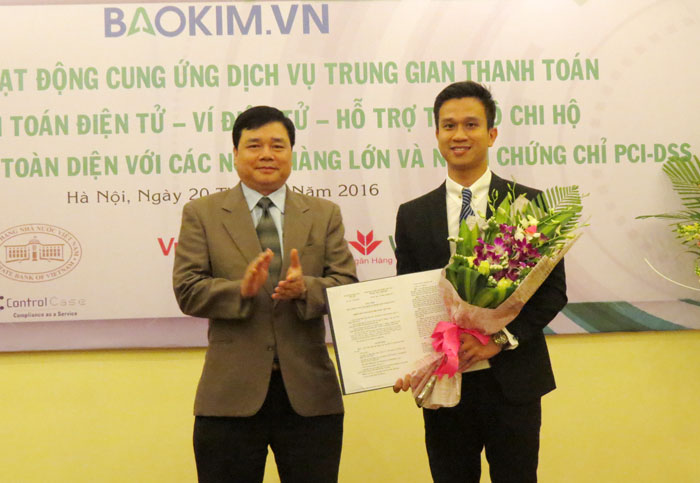 Ông Bùi Quang Tiên, Vụ trưởng Vụ thanh toán (bên trái) trao giấy phép cho ông Nguyễn Trung Đức, Giám đốc Bảo Kim