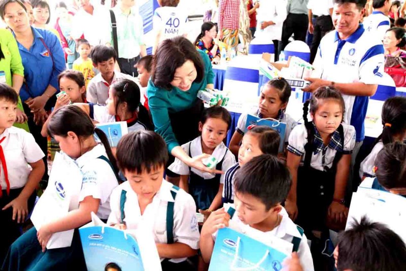 Bà Bùi Thị Hương, Giám Đốc Điều Hành Vinamilk trao tặng sữa cho các em học sinh Vĩnh Long.
