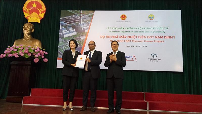 Thứ trưởng Bộ Kế hoạch và Đầu tư Đặng Huy Đông trao Giấy chứng nhận đầu tư cho đại diện nhà đầu tư Công ty TNHH điện lực Nam Định thứ 1