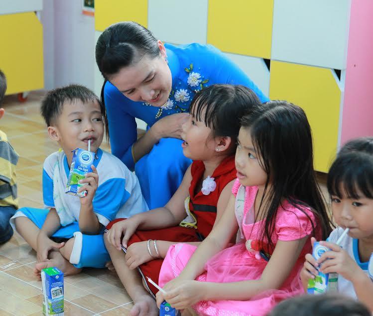 Cô giáo Nguyễn Thị Út và các em học sinh lớp 5 tuối trò chuyện trong lớp học mới cải tạo