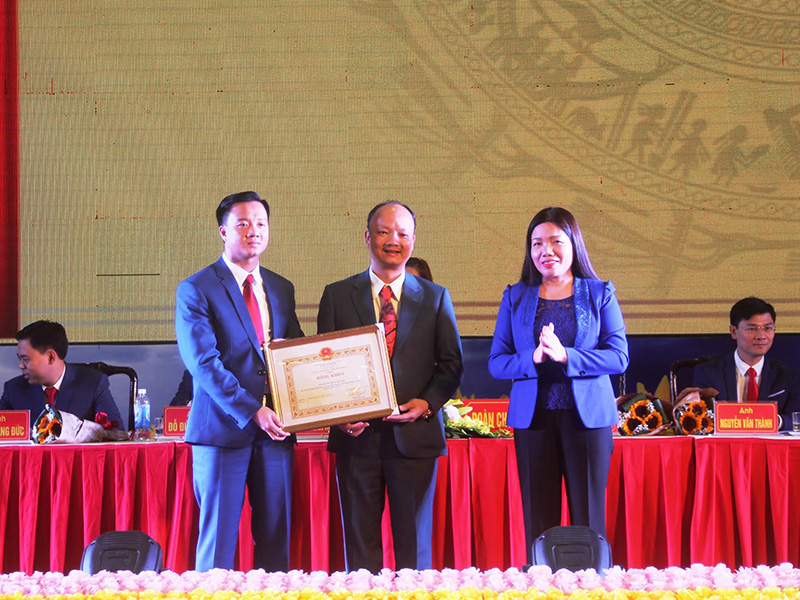 anh Nguyễn Xuân Hưng (trái) và anh Nguyễn Hồng Phong đón nhận bằng khen của chủ tịch UBND tỉnh Thanh Hóa dành cho Hội DNT Thanh Hóa khóa V.