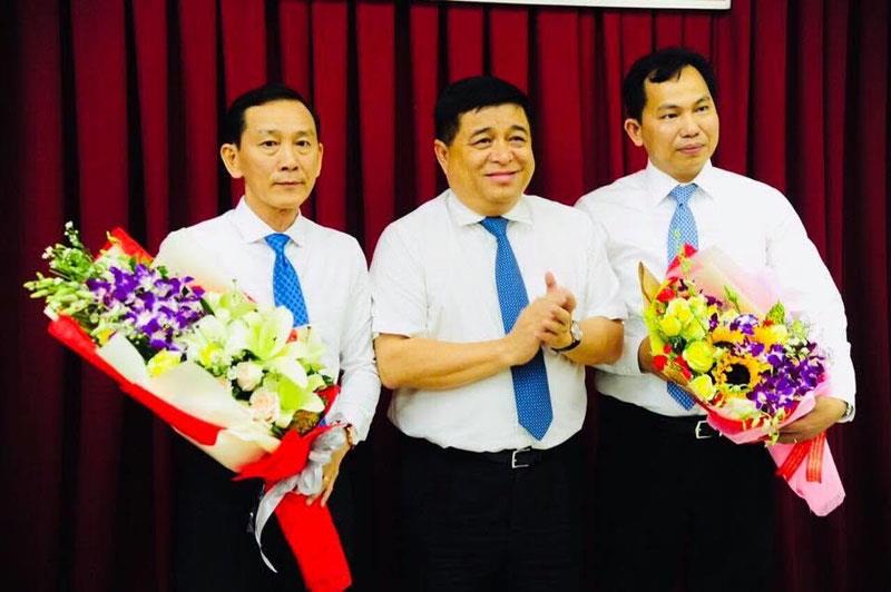 Bộ trưởng Bộ Kế hoạch và Đầu tư, Nguyễn Chí Dũng (đứng giữa) tặng hoa cho ông Lê Quang Mạnh (bìa phải) và ông Võ Thành Thống (bìa trái).