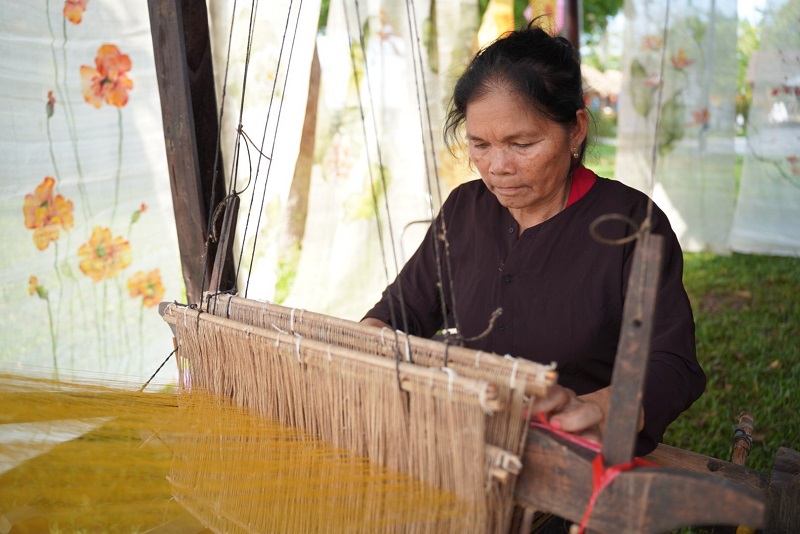 Một nghệ nhân thao diễn nghề dệt không gian thao diễn bên sông Hương (Ảnh: L.Đ.H)