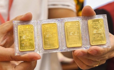 Vàng tiếp tục lao dốc dù Fed giảm thêm lãi suất USD